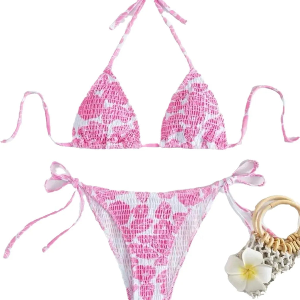 Women's pink floral halter neck swimsuit with briefs on a mannequin.