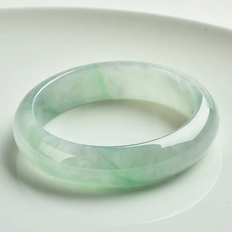 Light green jade bracelet showing natural stone texture on wrist