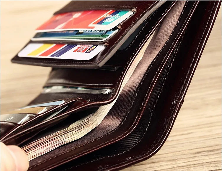 Men's black leather wallet showing multiple card slots, coin pocket, and document section