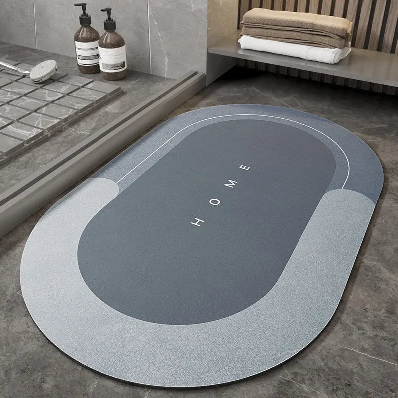 Blended fibre machine woven bathroom floor mat in blue, shown in an oval shape on a tiled floor.