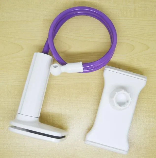 Black aluminium alloy and plastic bedside phone handset with long arm extended on a wooden table.