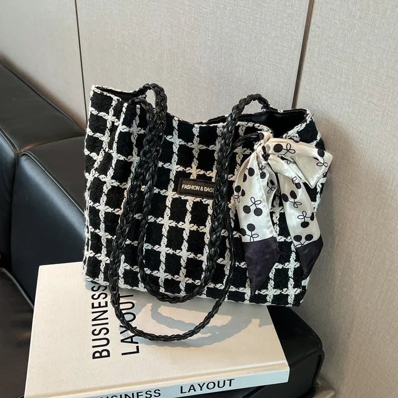 Wool blend shoulder bag in horizontal square shape with organisational compartments and woven sewing details