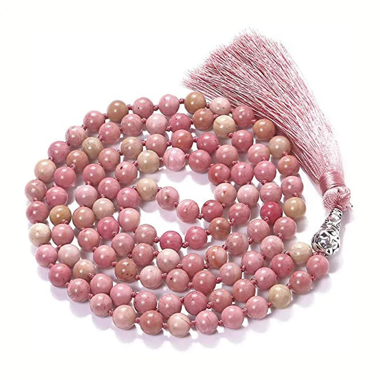 Long agate tassel necklace with geometric beads in multiple natural stone colours on a white background.