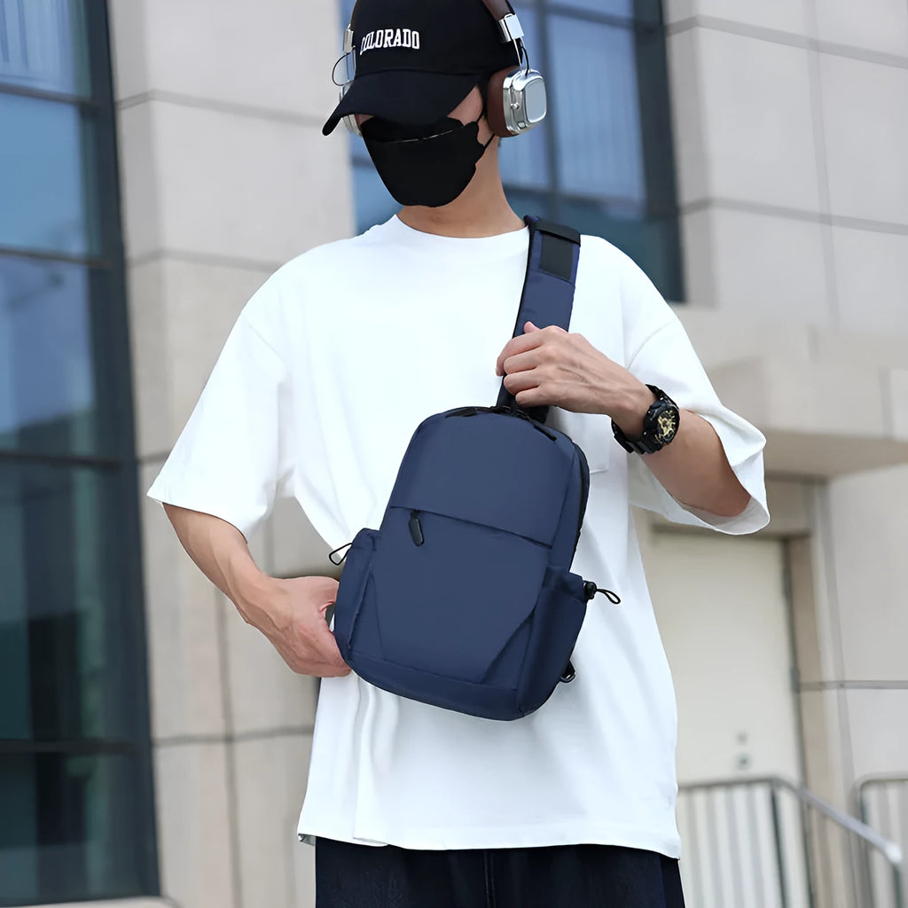 Grey mens chest bag showing shoulder strap and main compartment with waterproof exterior.
