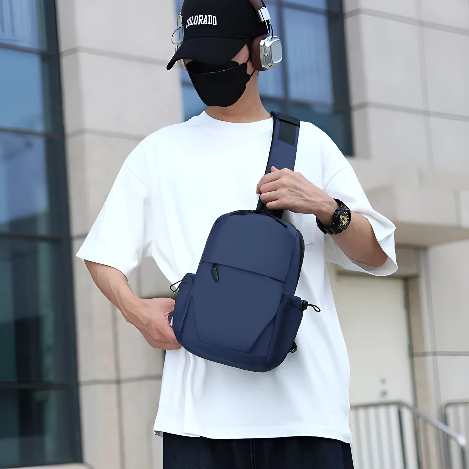 Grey mens chest bag showing shoulder strap and main compartment with waterproof exterior.