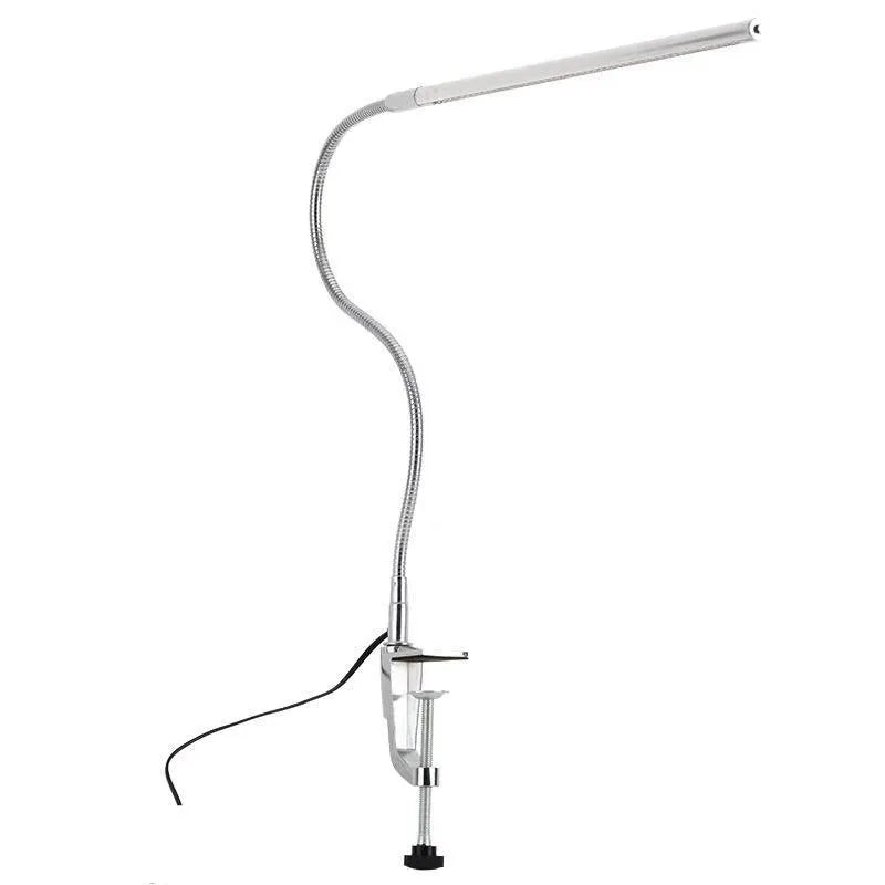 Silver LED clip-on table lamp with long arm extended, showing aluminium alloy construction and USB cable.