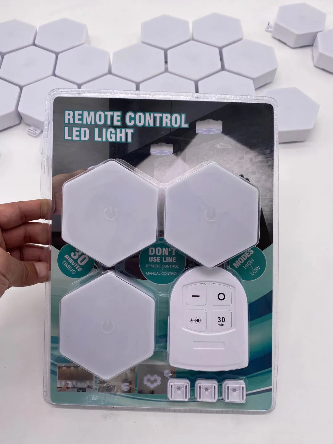 Small white rectangular wireless remote control LED pat light with touch panel.
