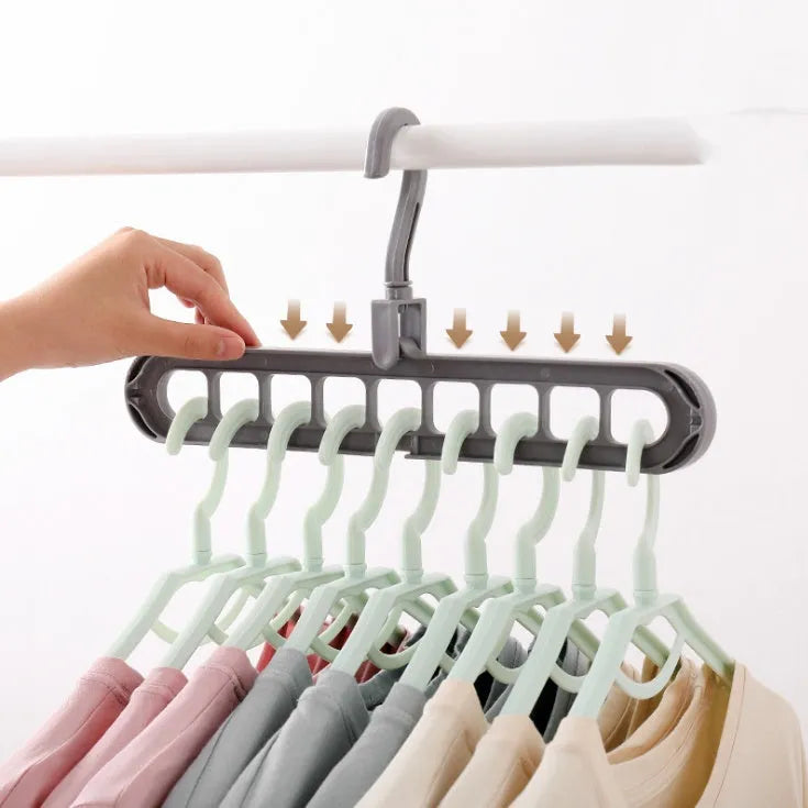Pink plastic clothes hanger with a 360-degree rotating hook on a white background.