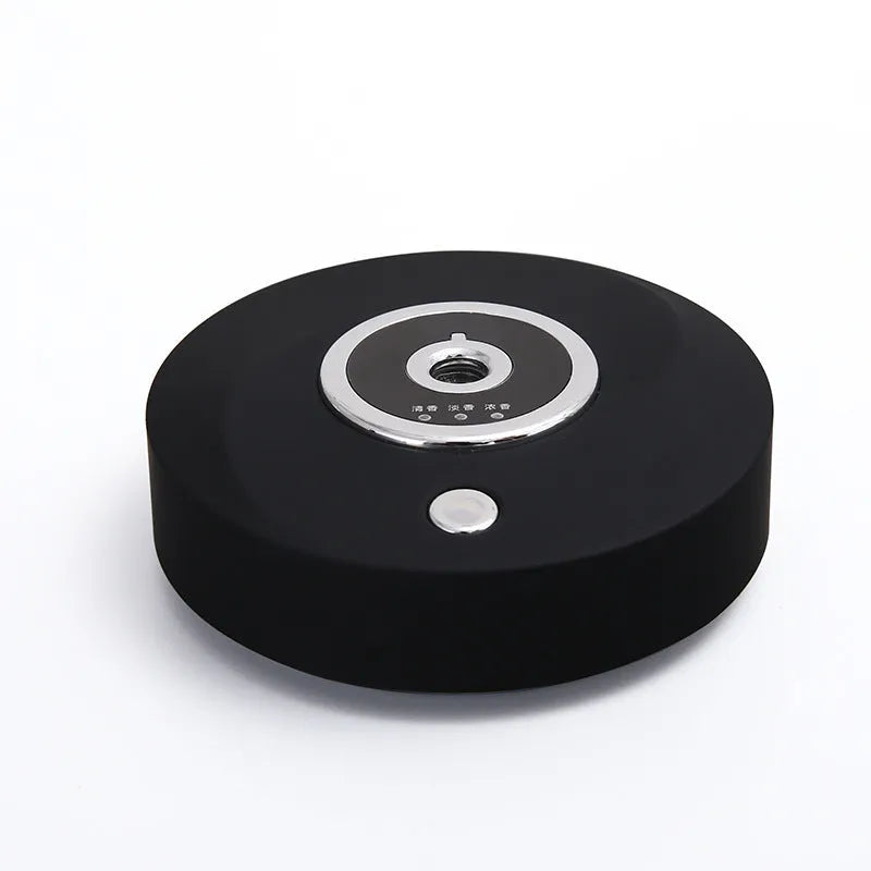 White plastic USB-powered car fragrance spray holder attached to a vehicle air vent.