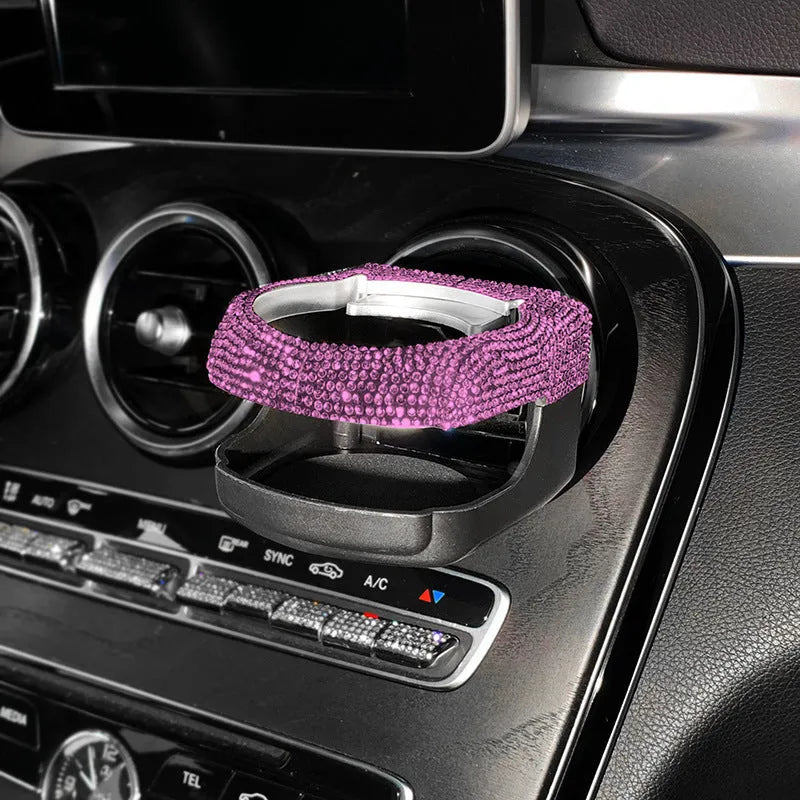 Car interior water cup bracket with decorative diamond accents mounted on air vent