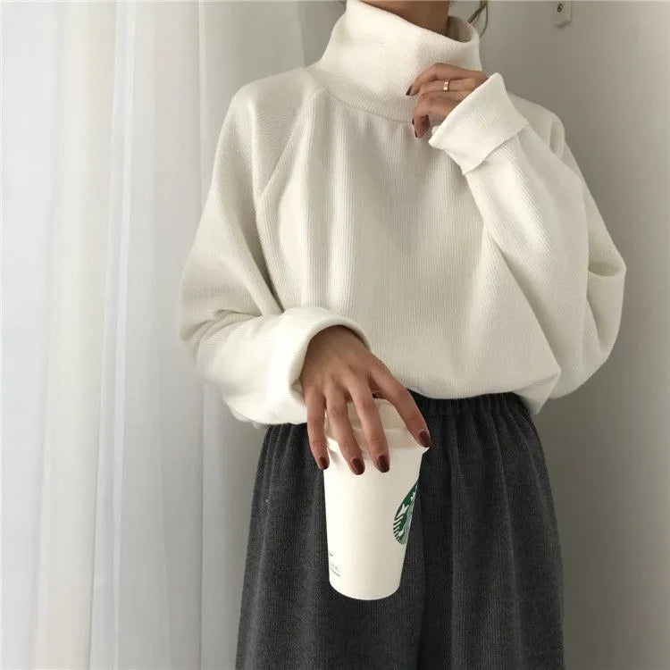 Women's solid colour long sleeve top with half-high collar in loose fit, shown in apricot