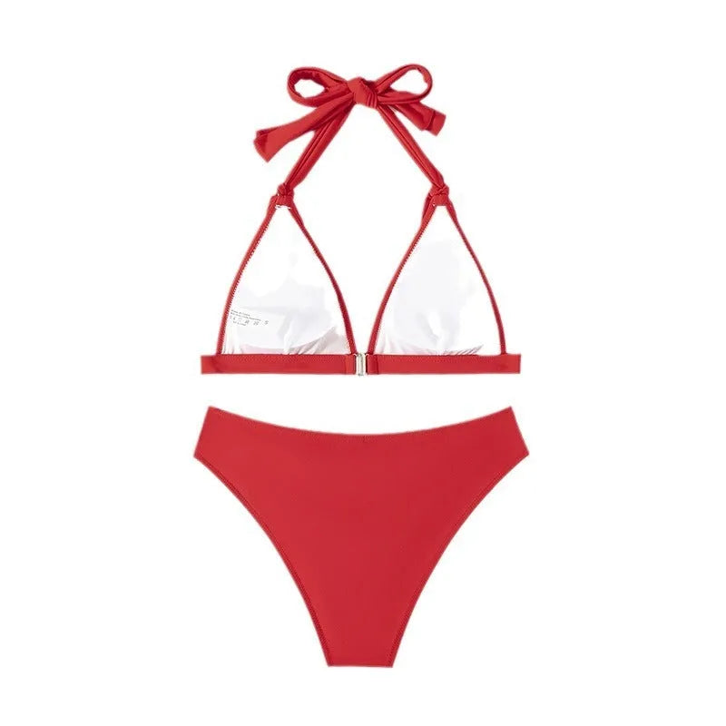 Red women's halterneck lace-up bikini with split shorts for swimming