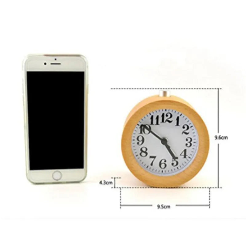Solid beech wood analogue alarm clock with silent snooze on a wooden bedside table.