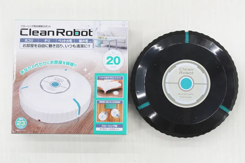 Black or white AC automatic sweeping robot on a hardwood floor next to a dust bin.