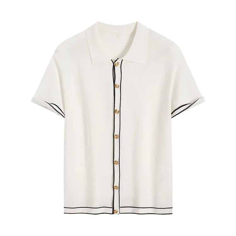 White women's short sleeve cardigan with dark contrast lapels laid flat.