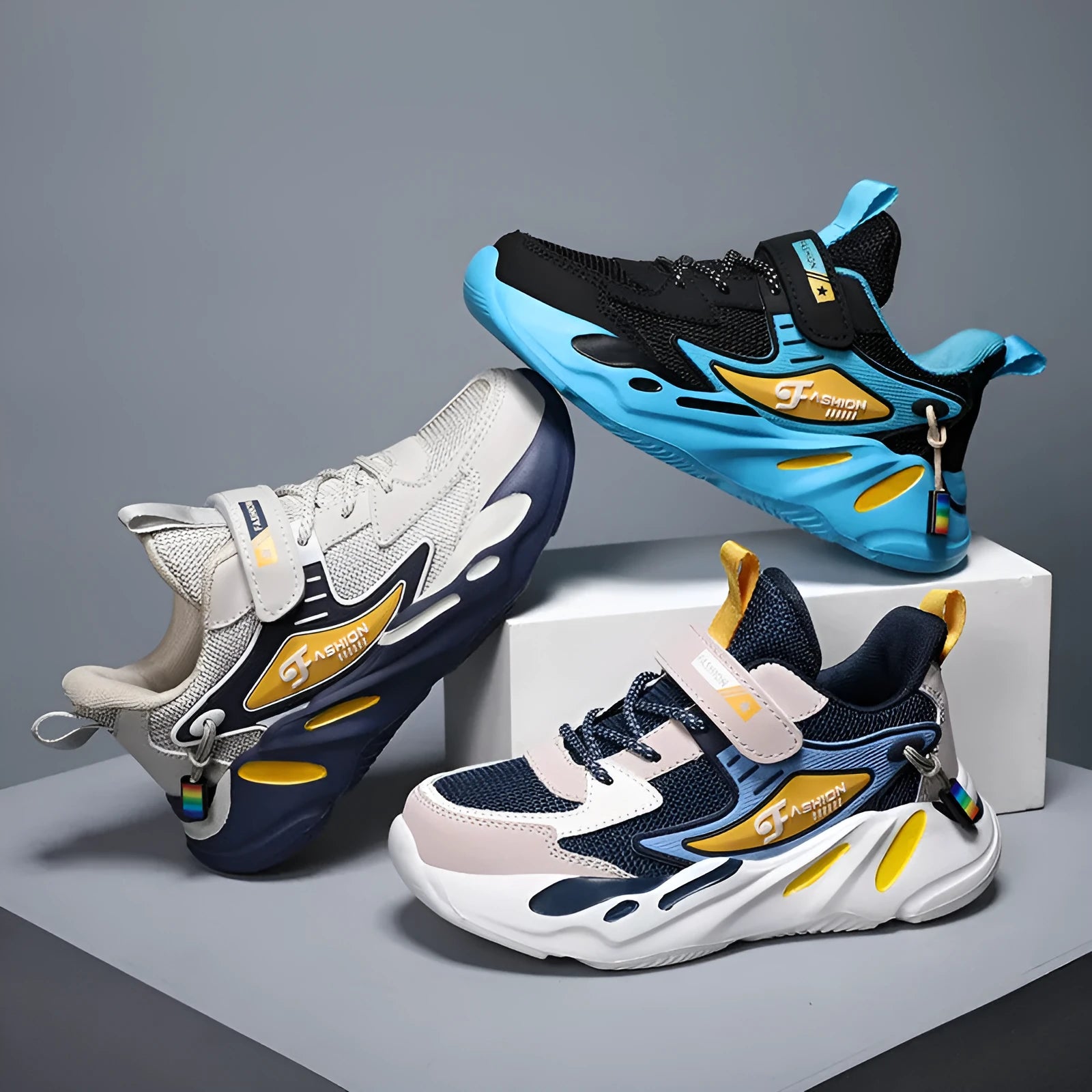 Boys sports running shoes in dark blue with a mesh upper and Velcro strap, shown on a hard ground surface.