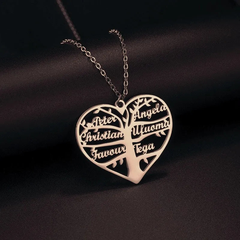 Custom stainless steel name necklace with heart and tree pendant, shown in silver, gold, and rose gold finishes.