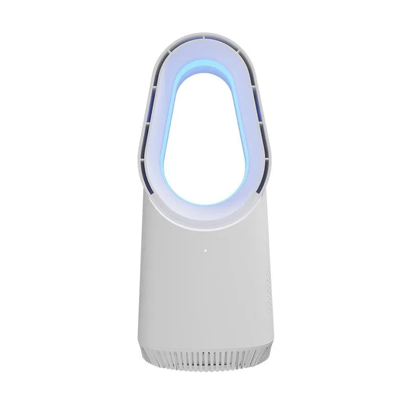 A white bladeless tower fan with a remote control on a wooden floor next to a desk.
