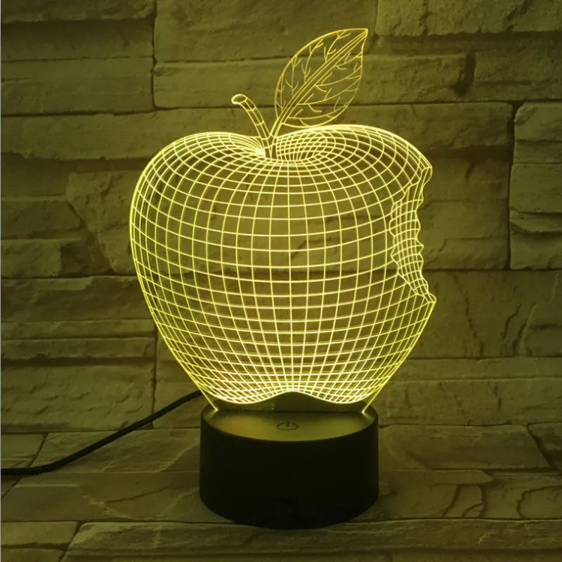 3D acrylic fruit-shaped night light with touch control and multi-colour LED illumination on a dark surface.