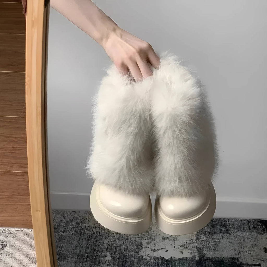 Women's black artificial plush snow boots with waterproof platform sole and low top design.