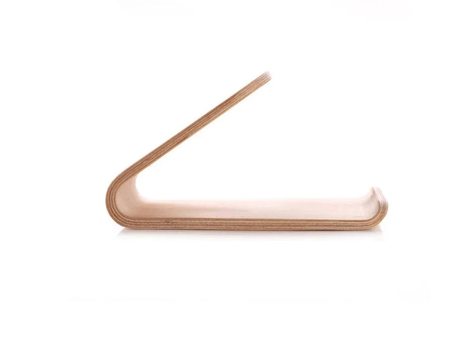Solid walnut wooden stand holding an iPhone with charging cable routed through integrated channel