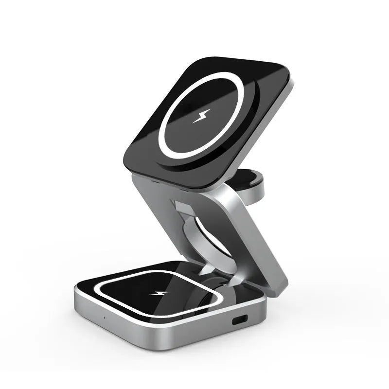 Three-in-one desktop wireless charging bracket unfolded on desk with iPhone, Samsung phone, and Google Pixel Watch positioned for charging