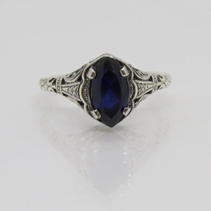 Women's silver geometric hollow ring showing alloy construction and patterned design