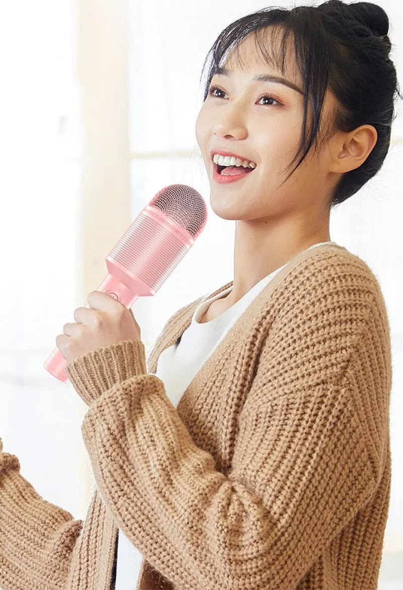 Handheld wireless Bluetooth karaoke microphone in pink, blue, and green colour options.