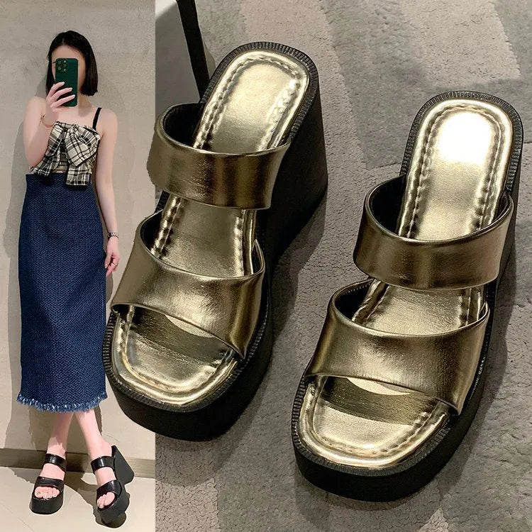 Women's black wedge platform slippers with square toe design on grey background