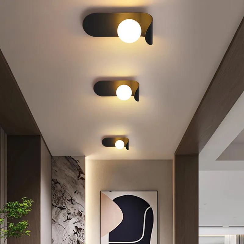 Modern minimalist black iron wall lamp with LED light for bedside or living room wall