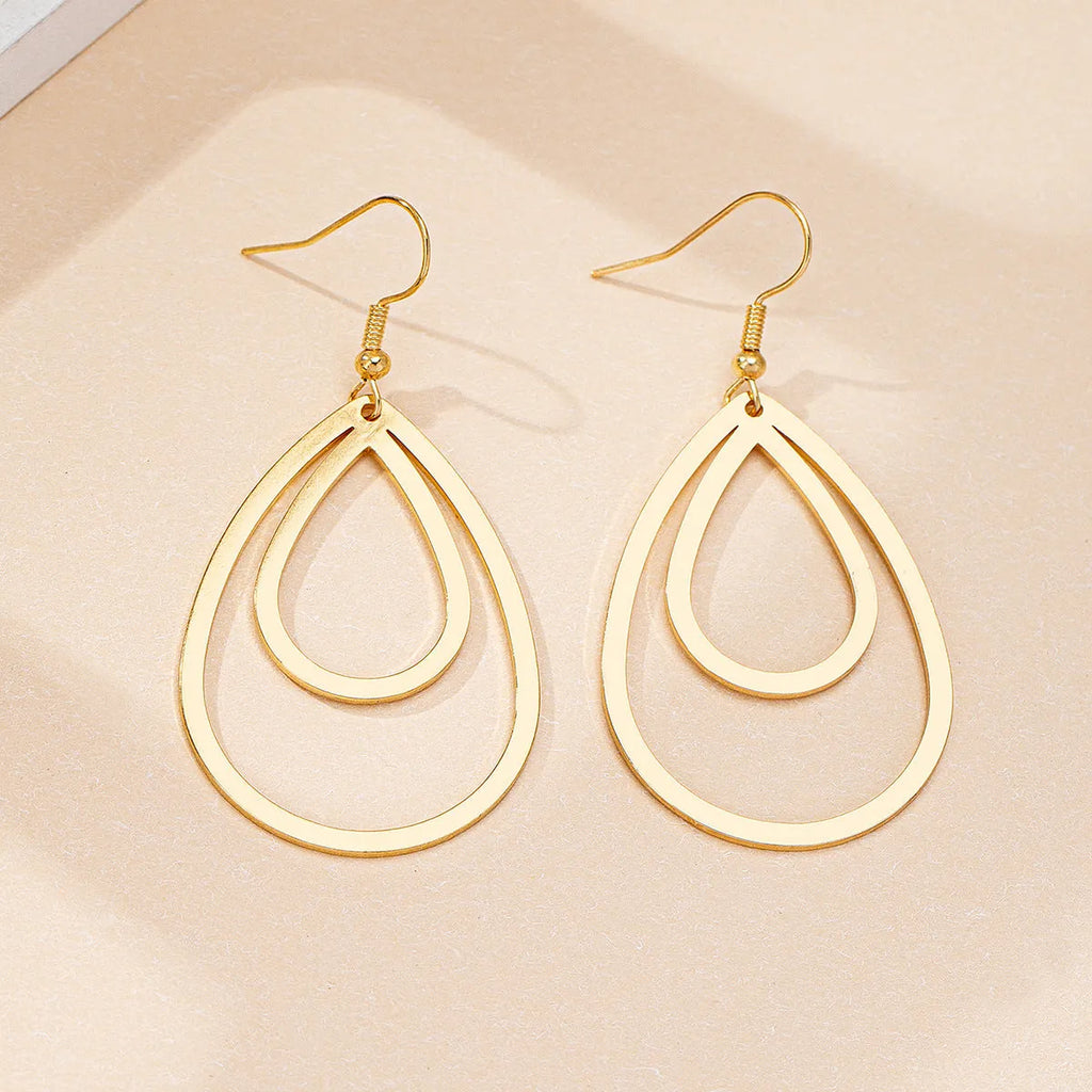 Golden yellow hollow drop earrings made from iron, shown as a pair with an open drop shape