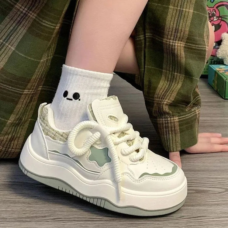 Women's green patent leather platform sneakers with round toe and white laces
