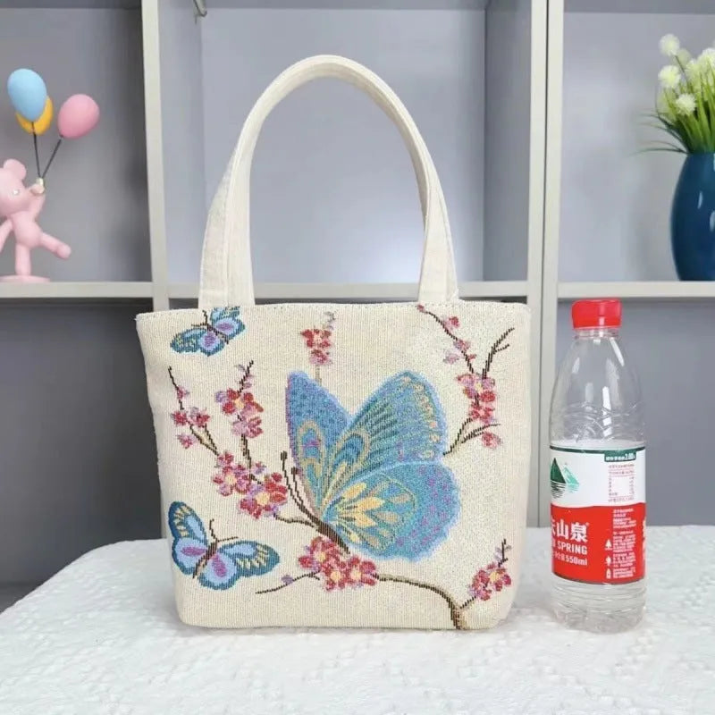 Double-sided embroidered canvas bag with gold wire detailing showing botanical pattern