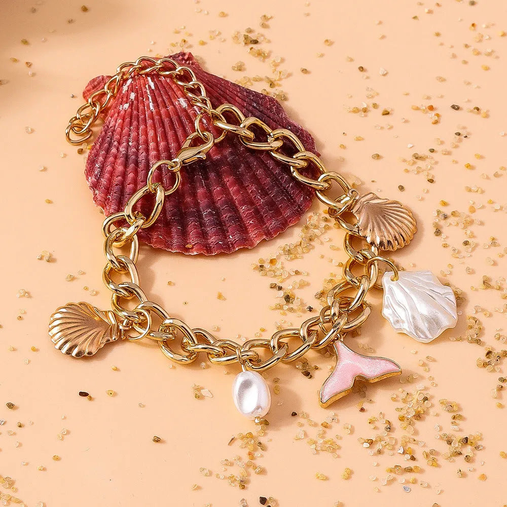 Women's shell pearl mermaid tail bracelet in white pearl alloy finish