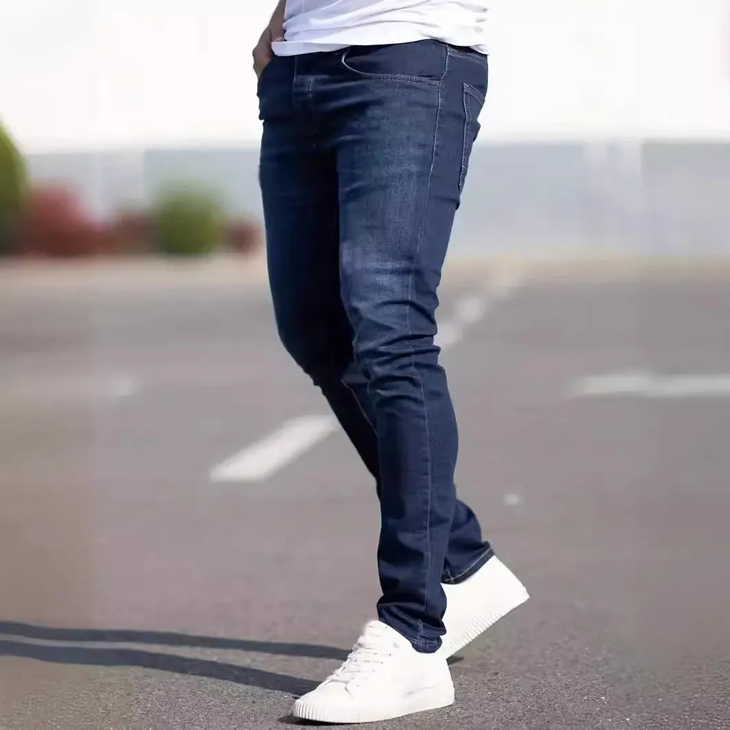 Dark blue men's slim fit skinny jeans with zipper fly on mid waist