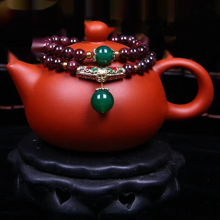 Natural garnet bracelet with 7mm beads, double gold ring clasp, and golden toad charm.