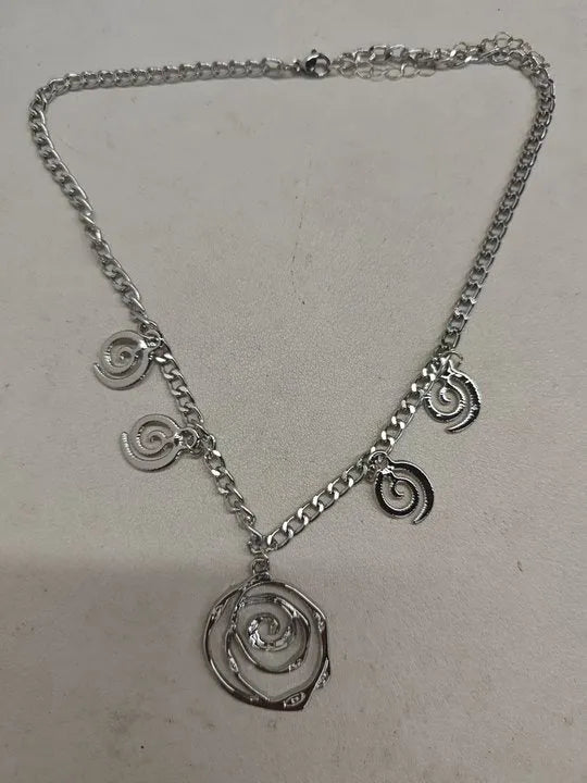 Women's spiral donut jewellery set showing necklace, bracelet and earrings in gold finish