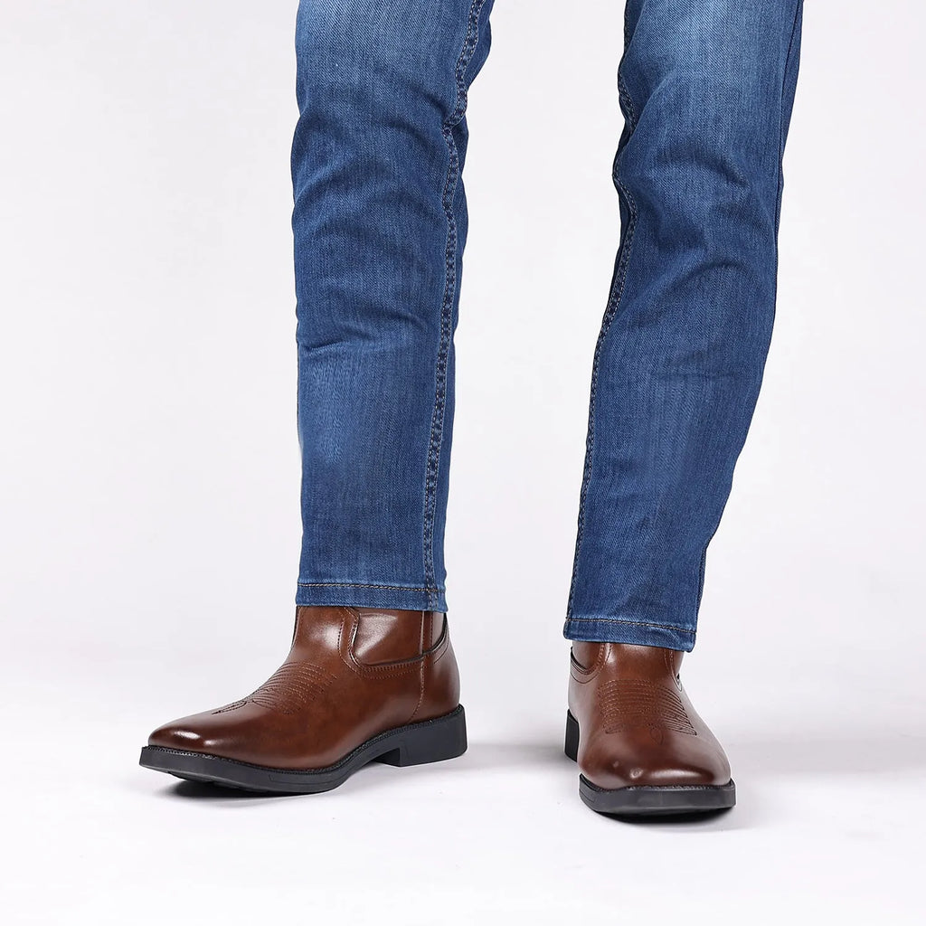 Man's brown retro cowboy boot with high embroidery, wide square toe, and high shaft on a neutral background.