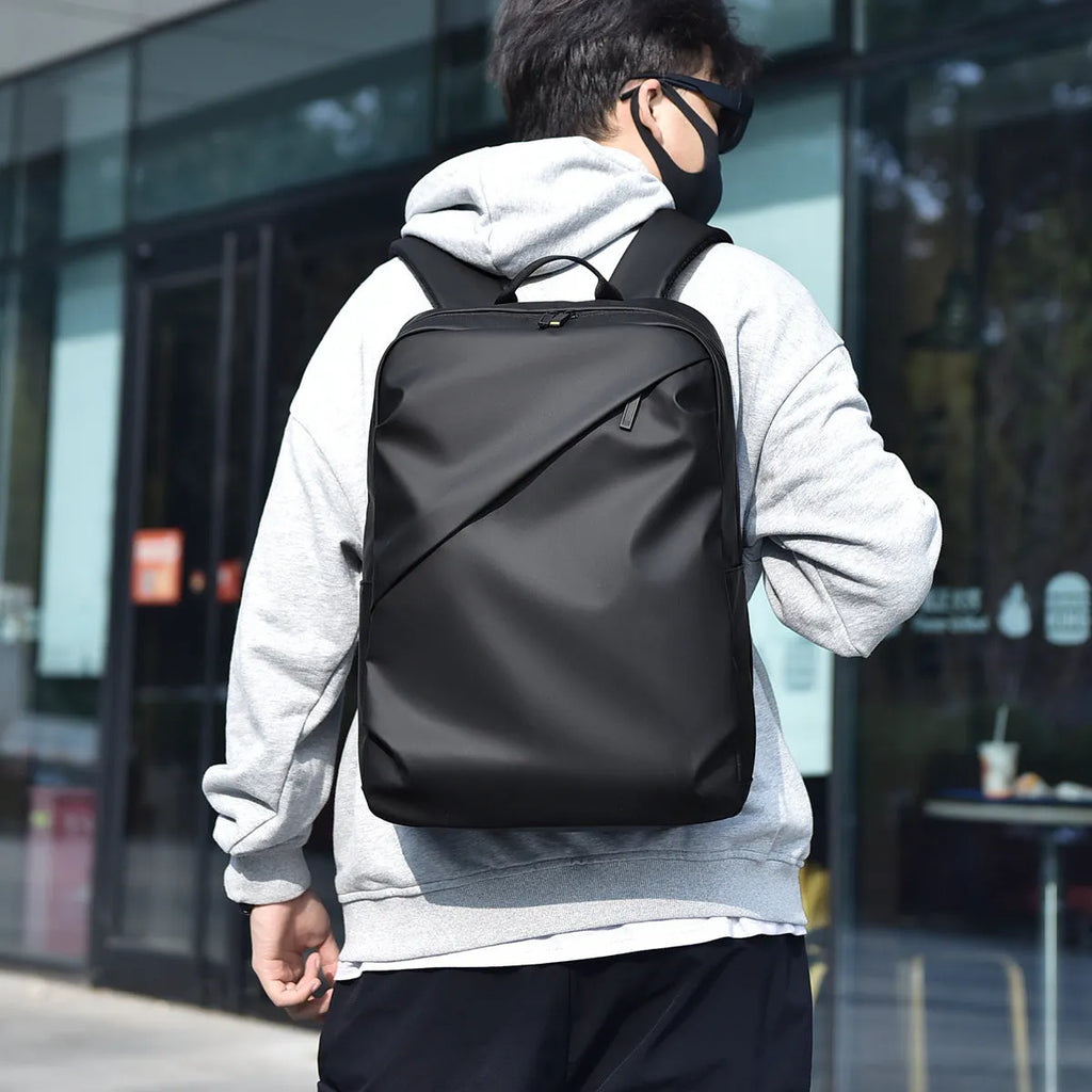Simple black PU leather backpack with visible sewing thread detailing and large storage capacity