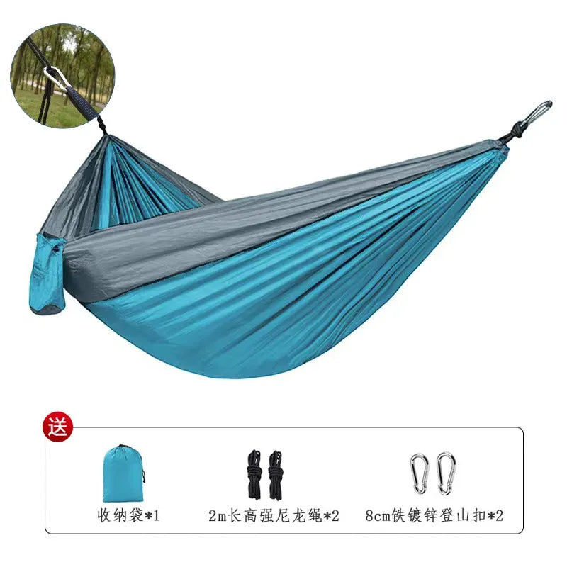 Blue nylon parachute cloth outdoor hammock hung between two trees showing full 270 cm length