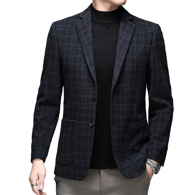 Man wearing a solid grey loose-fit woolen suit jacket with long sleeves.