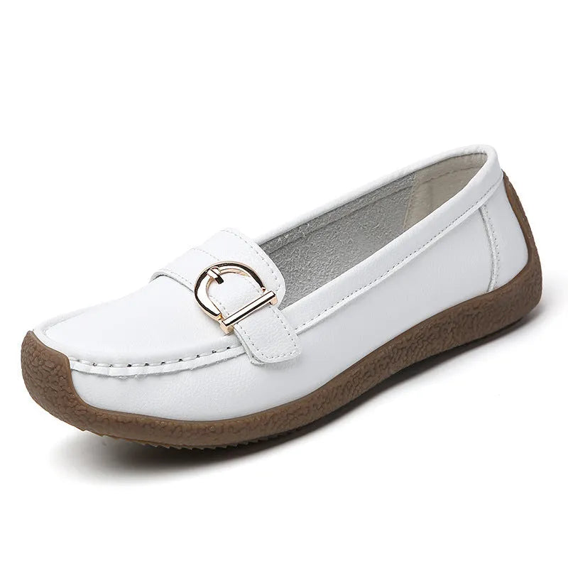 Women's beige casual loafers with round toe and flat heel on a light background.