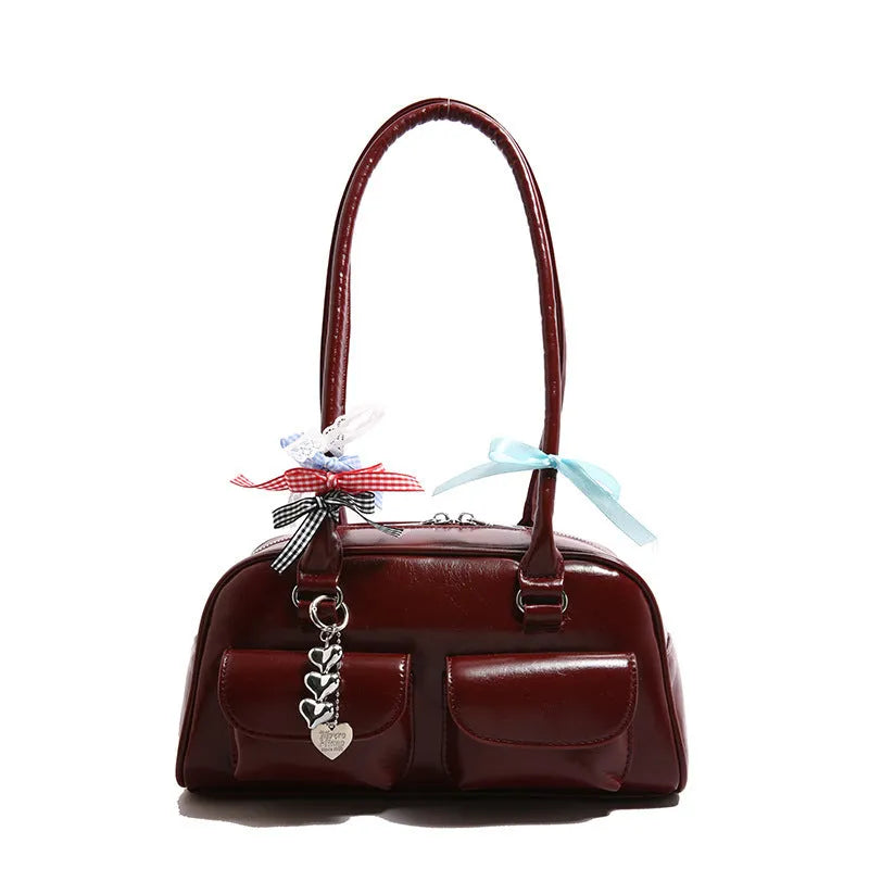 Retro style women's PU leather pillow-shaped flap handbag in black, shown with a double shoulder strap.