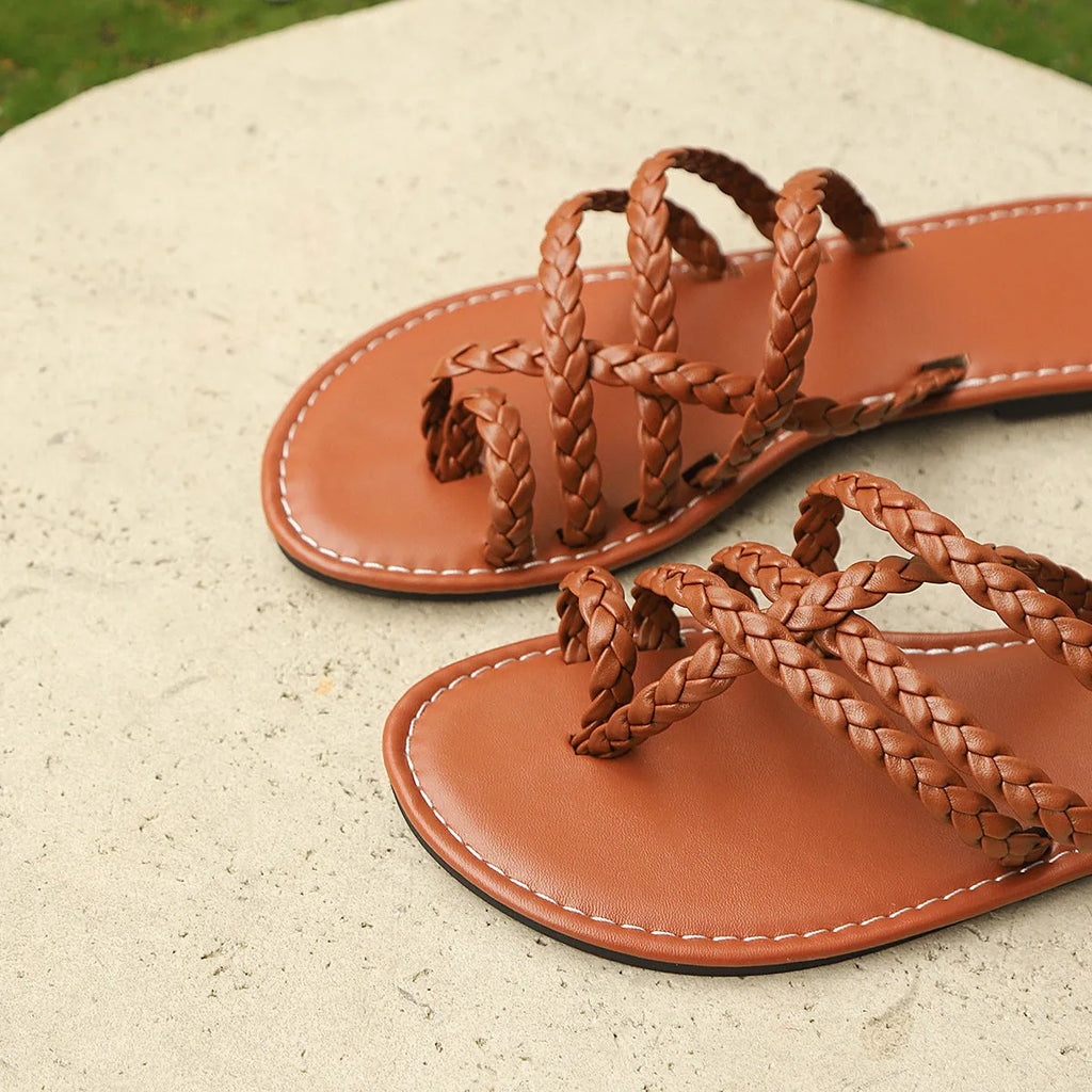 Women's flat woven sandals with a clip-toe fastening and rubber sole in three colour options.