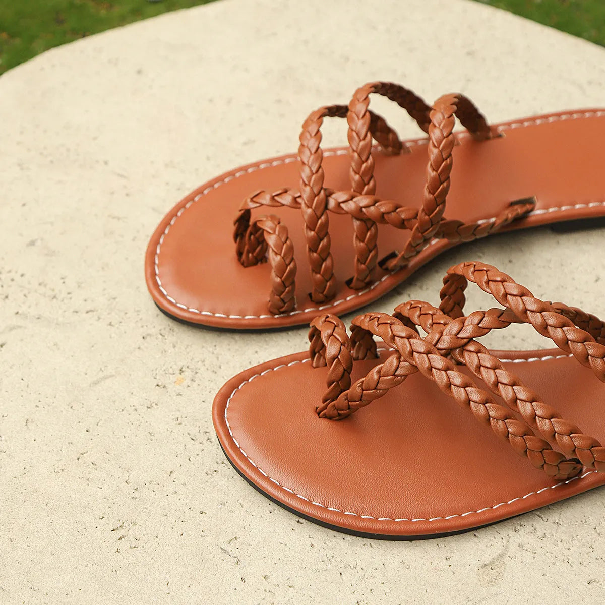 Women's flat woven sandals with a clip-toe fastening and rubber sole in three colour options.