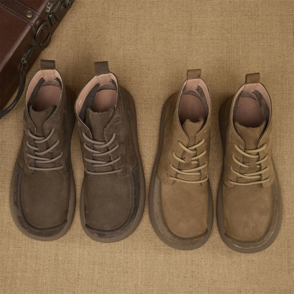 British style grey leather Martin boots with lace-up front and wedge heel on a rubber sole.