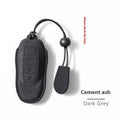 Suede car key cover shown in Cement Gray, Dark Green, Light Gray, and Orange colour options.