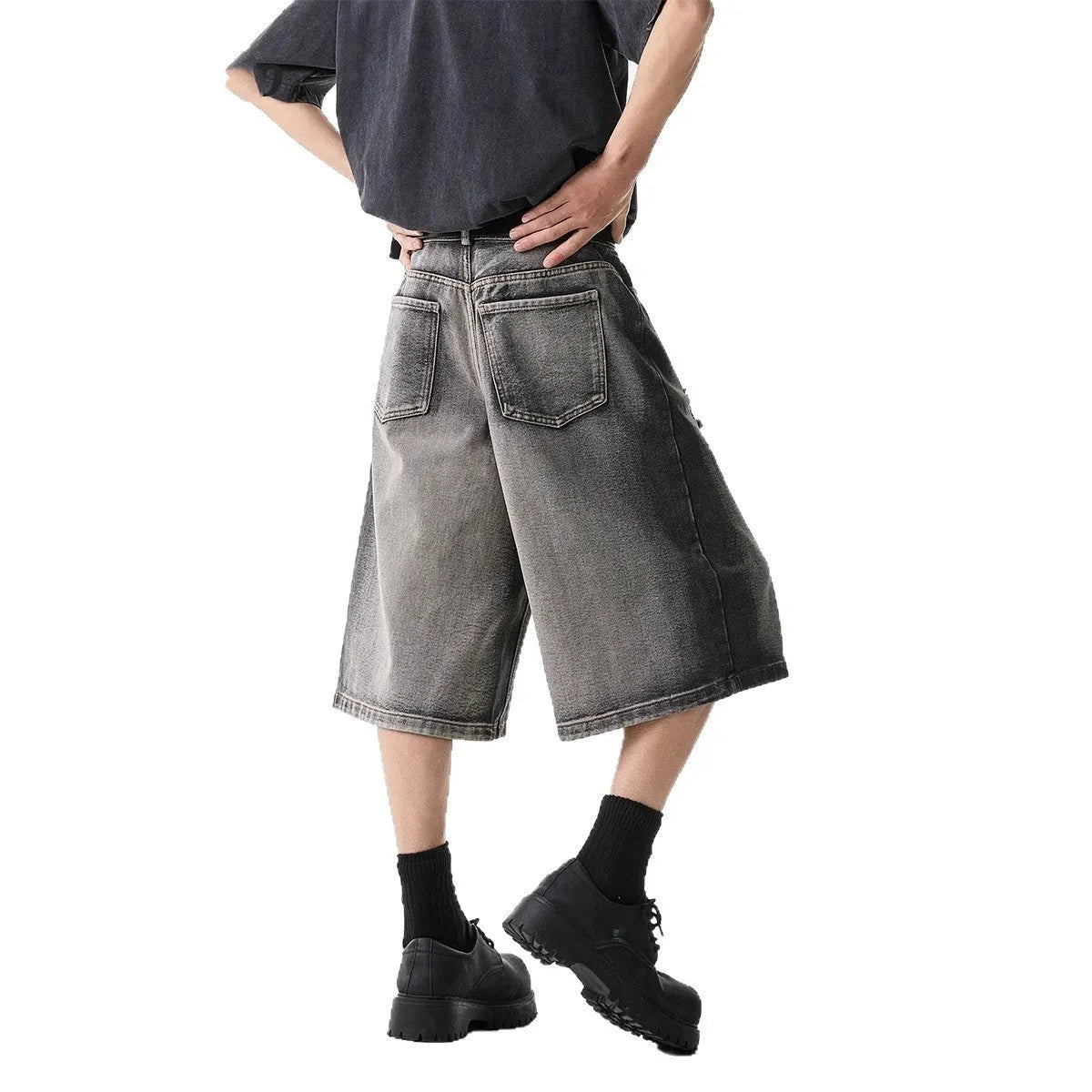 Grey denim shorts with loose fit and cropped length on hanger