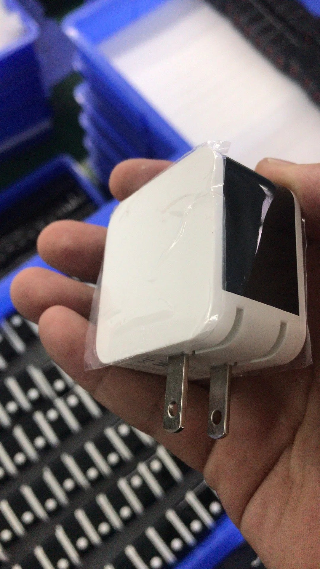 Black dual USB fast travel charger with digital display showing charging status and EU standard plug.