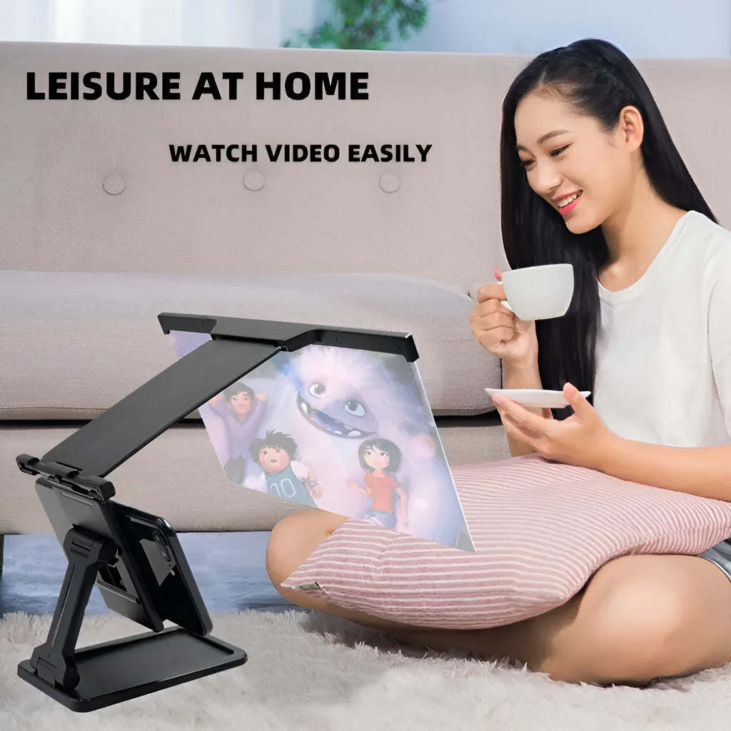 Black folding mobile phone screen magnifier with detachable holder next to an iPhone